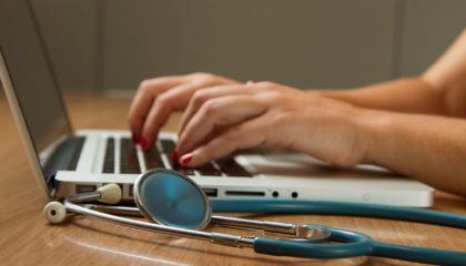 national-cancer-institute-NFvdKIhxYlU-unsplash Nurse at the Cancer Institute typing