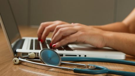 Nurse at the Cancer Institute typing